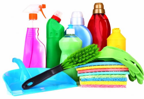 Cleaner handling recyclable materials in Canary Wharf office setting
